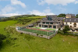 Unparalleled five bedroom family home in a superb location / Approximately thirty acres of grounds including equestrian facilities / World-class leisure facilities, including a breathtaking indoor pool