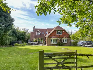 CHARMING DETACHED FIVE BEDROOM TUDOR-STYLE COUNTRY HOME SET AT THE FOOTHILLS OF THE SOUTH DOWNS NATIONAL PARK IN SMALL DOLE, WITH 2.8 ACRES OF LAND AND VIEWS TOWARDS STEYNING AND CHANCTONBURY RING.