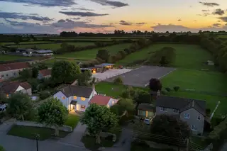 A beautifully renovated four-bedroom village home with land, stables and Olympic sized arena