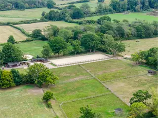 Hillside is a distinguished 6-bed country home in Storrington, set within 17 acres with modern equestrian facilities including sand school, stables and paddocks, plus over 4,700 sq. ft. of versatile family living and leisure space.