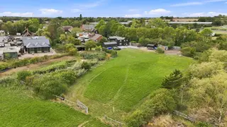 A fabulous residence with equestrian potential, it’s own mooring backing onto the tidal River Crouch & stunning south facing grounds